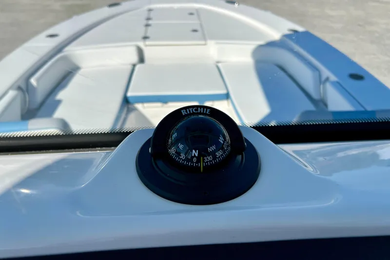 Slide: The Image of Compass on 2026 Robalo 246 Cayman boat, showcasing sleek interior design. - 31