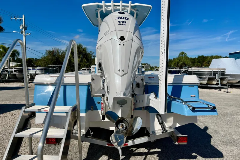 Slide: The Image of 2026 Robalo 246 Cayman boat with powerful 300 V6 engine, parked outdoors. - 7