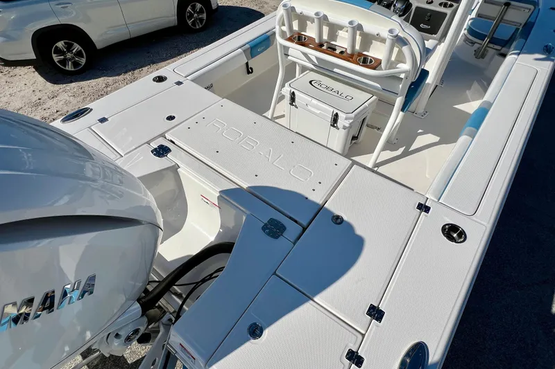 Slide: The Image of 2026 Robalo 246 Cayman boat interior with Yamaha engine, featuring spacious deck and storage. - 9