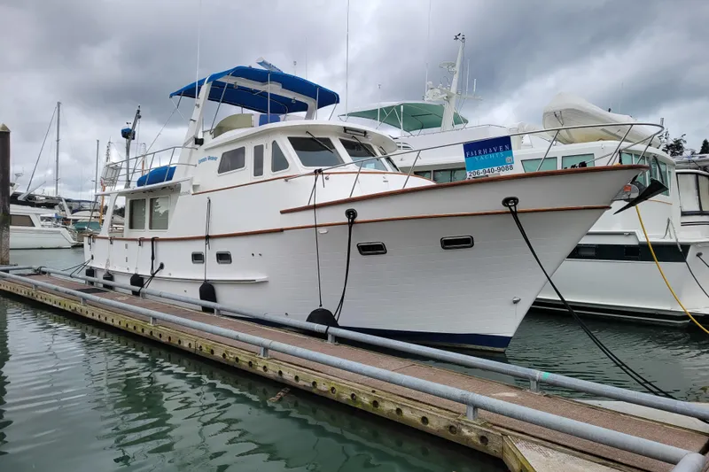 The Image of 2001 DeFever Pilothouse yacht docked at marina under cloudy skies. - 0