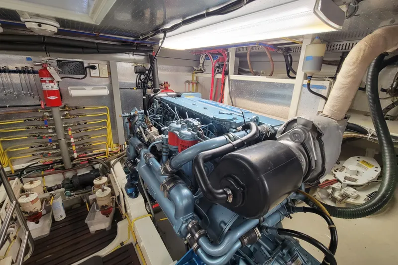 Slide: The Image of Engine room of a 2001 DeFever Pilothouse yacht, showcasing detailed machinery and equipment. - 13