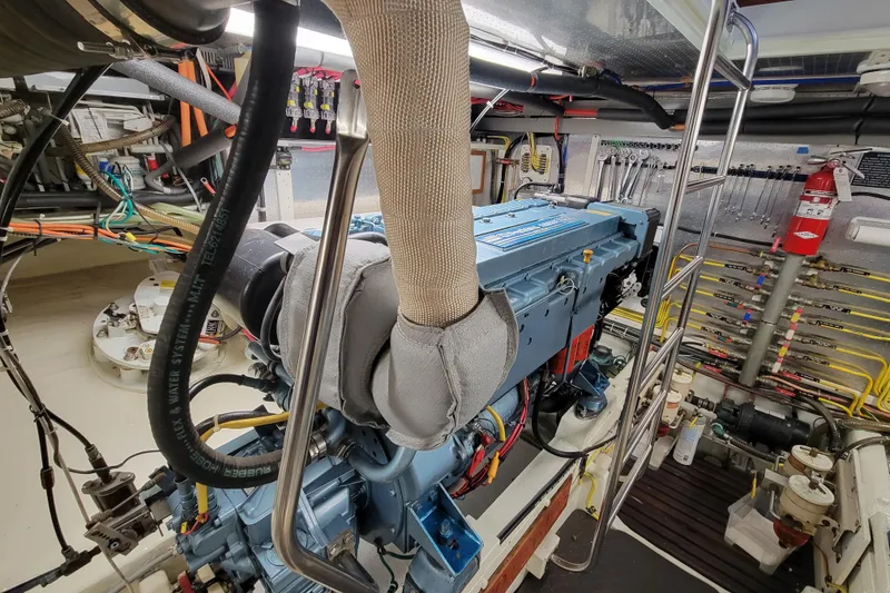 Slide: The Image of Engine room of a 2001 DeFever Pilothouse yacht, showcasing detailed machinery and equipment. - 14