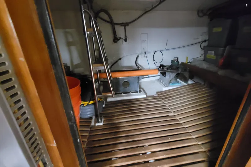 Slide: The Image of Engine room of 2001 DeFever Pilothouse with equipment and storage containers. - 17