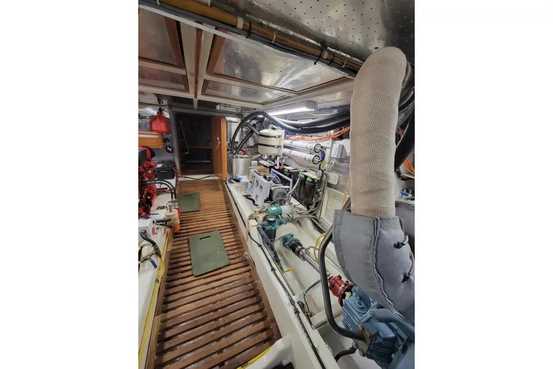 Slide: The Image of Engine room of a 2001 DeFever Pilothouse yacht with visible machinery and equipment. - 18