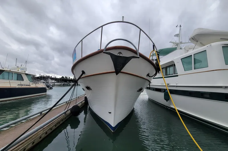 Slide: The Image of 2001 DeFever Pilothouse yacht docked at marina under cloudy skies. - 2