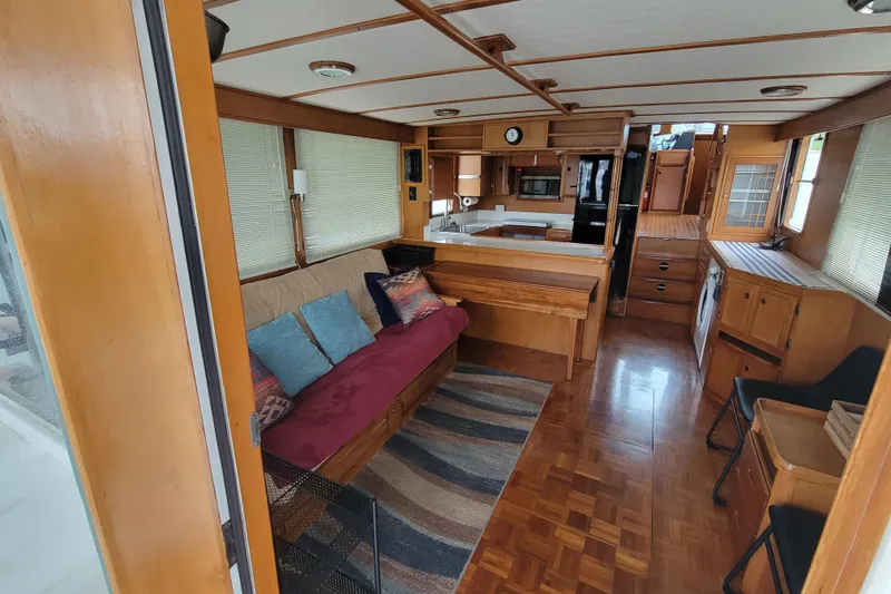 Slide: The Image of Interior of 2001 DeFever Pilothouse yacht with cozy seating and modern kitchen amenities. - 20