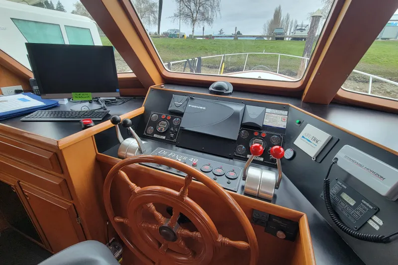 Slide: The Image of Pilothouse interior of 2001 DeFever yacht with steering wheel and navigation equipment. - 27