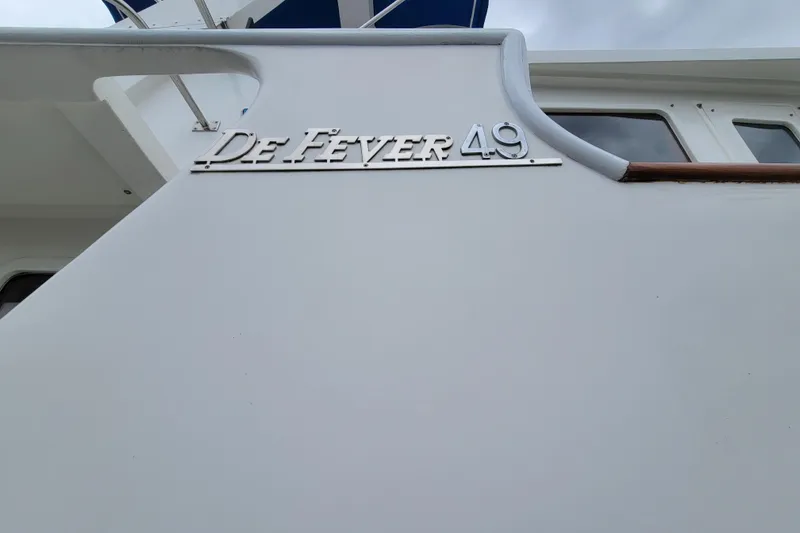 Slide: The Image of 2001 DeFever Pilothouse yacht with "DeFever 49" emblem on the side. - 3