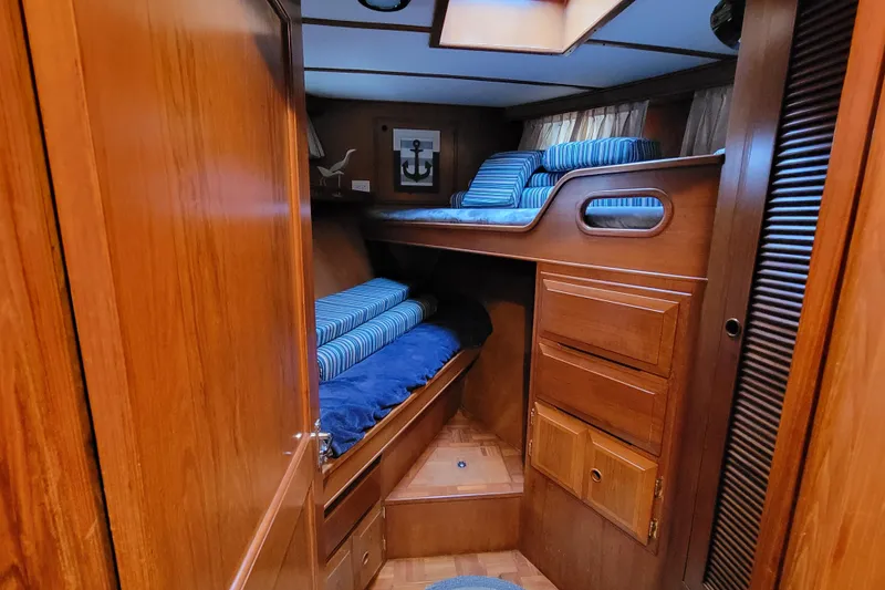 Slide: The Image of Cozy wooden cabin interior of 2001 DeFever Pilothouse with bunk beds and nautical decor. - 30