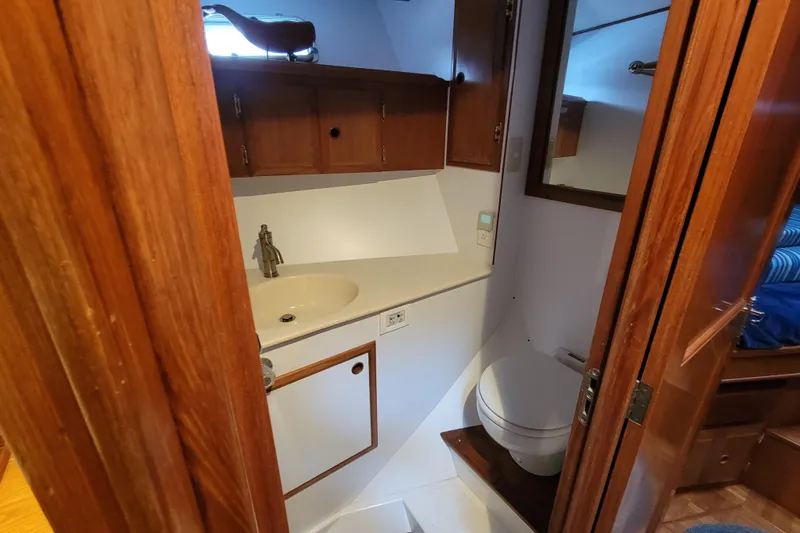Slide: The Image of 2001 DeFever Pilothouse bathroom with wooden cabinets and compact design. - 31