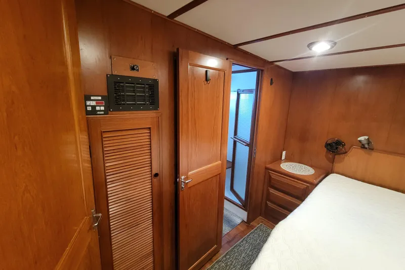 Slide: The Image of Interior of 2001 DeFever Pilothouse with wooden paneling and cozy bedroom. - 35