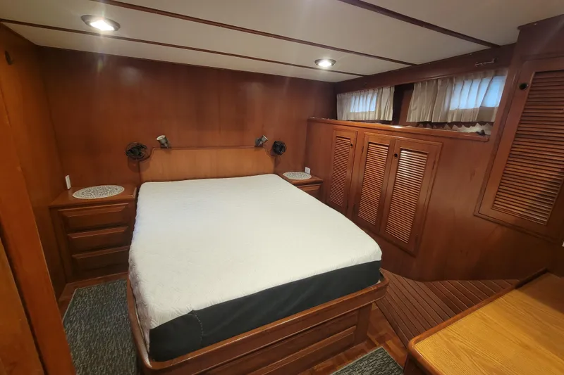 Slide: The Image of Luxurious 2001 DeFever Pilothouse bedroom with wood paneling and cozy bed. - 36