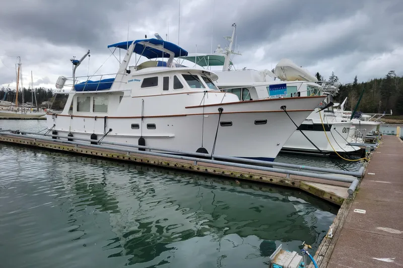 Slide: The Image of 2001 DeFever Pilothouse yacht docked at marina under cloudy skies. - 39