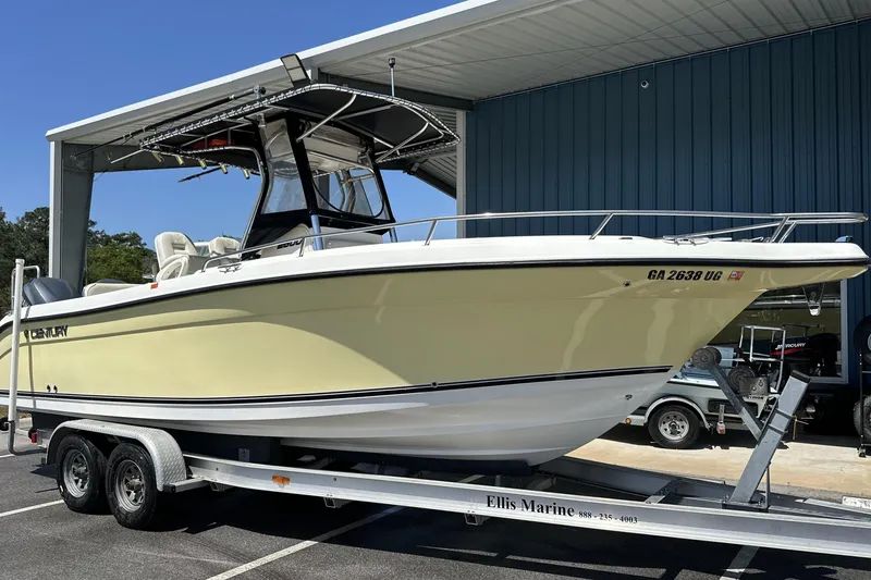 The Image of 2007 Century 2600 Center Console boat on trailer at marina, side view. - 0