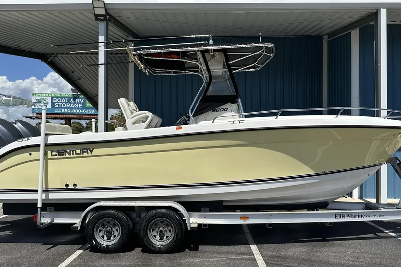 Slide: The Image of 2007 Century 2600 Center Console boat on trailer, parked under a canopy. - 1