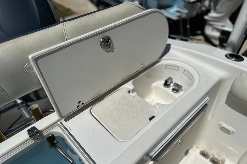 Slide: The Image of 2007 Century 2600 Center Console boat with open storage compartment and seating area. - 11