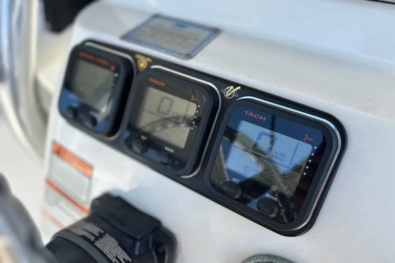 Slide: The Image of Close-up of 2007 Century 2600 Center Console boat dashboard with tachometer displays. - 12