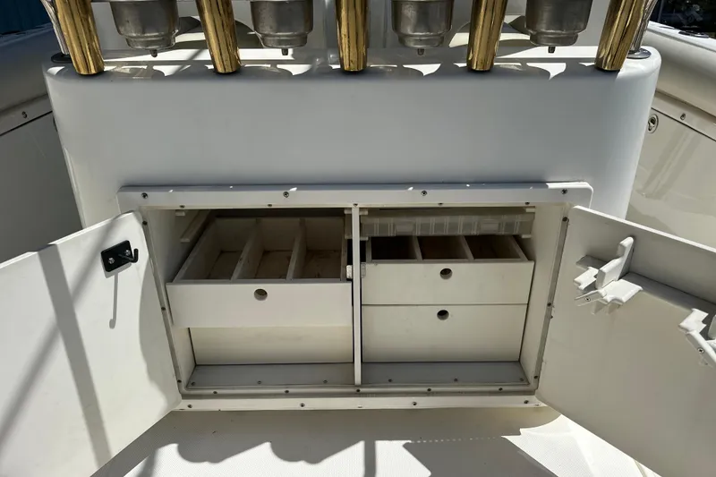 Slide: The Image of Open storage compartment on a 2007 Century 2600 Center Console boat, featuring organized drawers. - 14