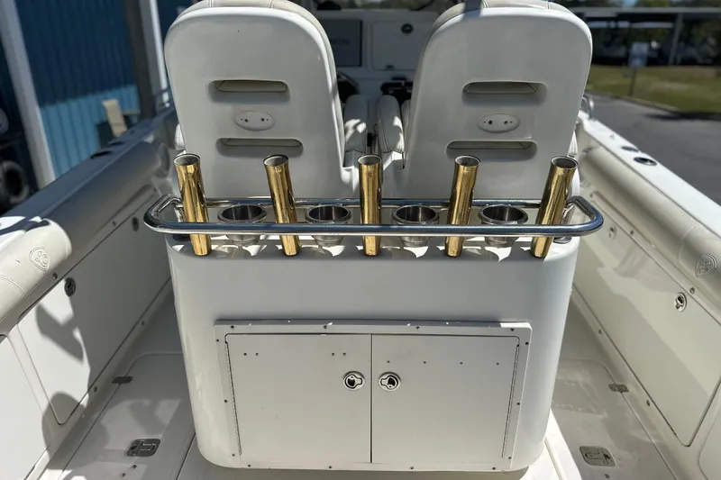 Slide: The Image of 2007 Century 2600 Center Console boat with rod holders and storage compartment. - 16