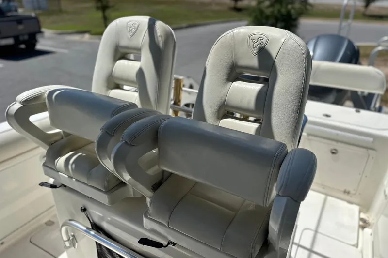 Slide: The Image of Two white cushioned seats on a 2007 Century 2600 Center Console boat. - 25