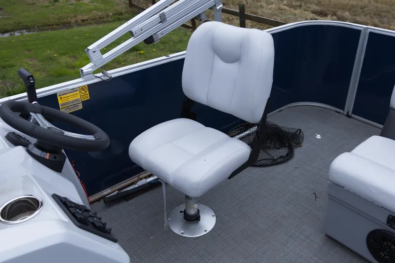 Slide: The Image of 2022 Bentley Pontoons Lil Bentley 180 Fish interior with white captain's chair and steering wheel. - 11