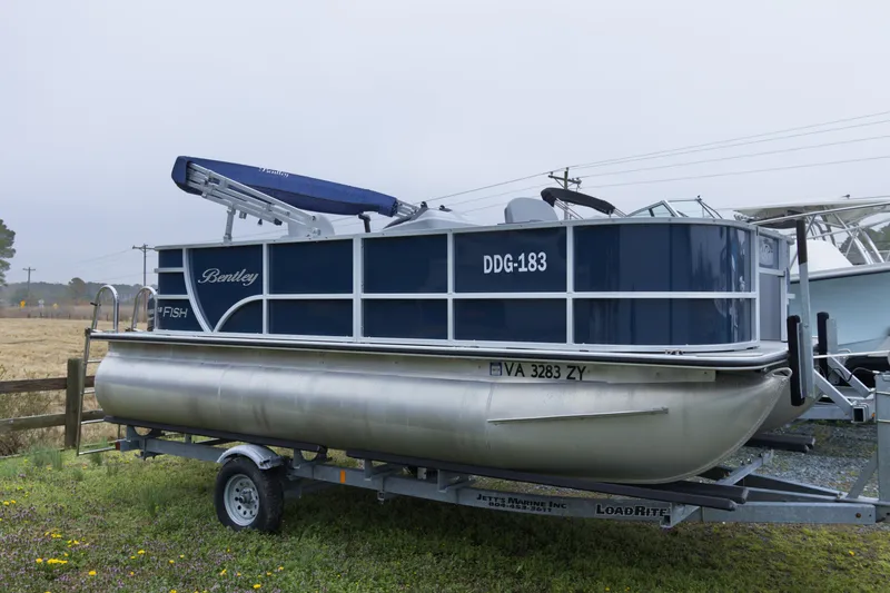 Slide: The Image of 2022 Bentley Pontoons Lil Bentley 180 Fish on trailer, blue and silver design. - 3