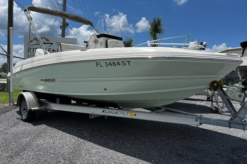 Slide: The Image of 2020 Stingray 186 CC boat on trailer, parked outdoors under a clear sky. - 2