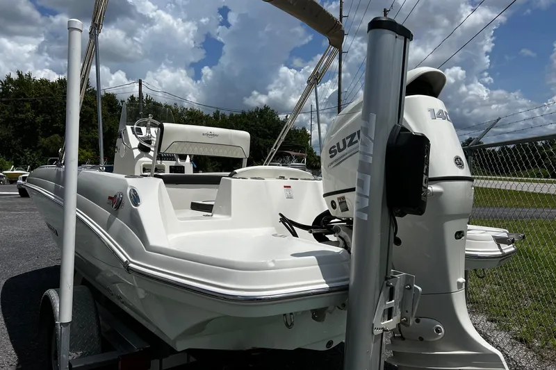 Slide: The Image of 2020 Stingray 186 CC boat with Suzuki outboard motor, parked on a trailer. - 4