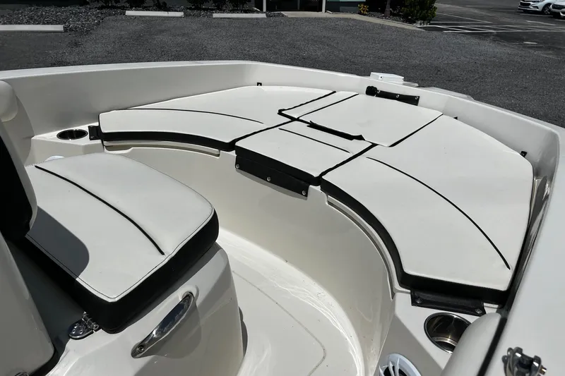 Slide: The Image of 2020 Stingray 186 CC boat interior with cushioned seating and cup holders. - 8