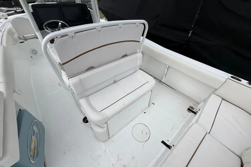 Slide: The Image of 2021 Sea Hunt Ultra 255 SE boat interior with white seating and modern dashboard. - 11