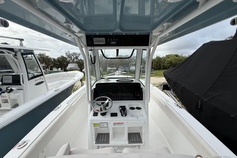 Slide: The Image of 2021 Sea Hunt Ultra 255 SE boat interior with steering wheel and control panel. - 14