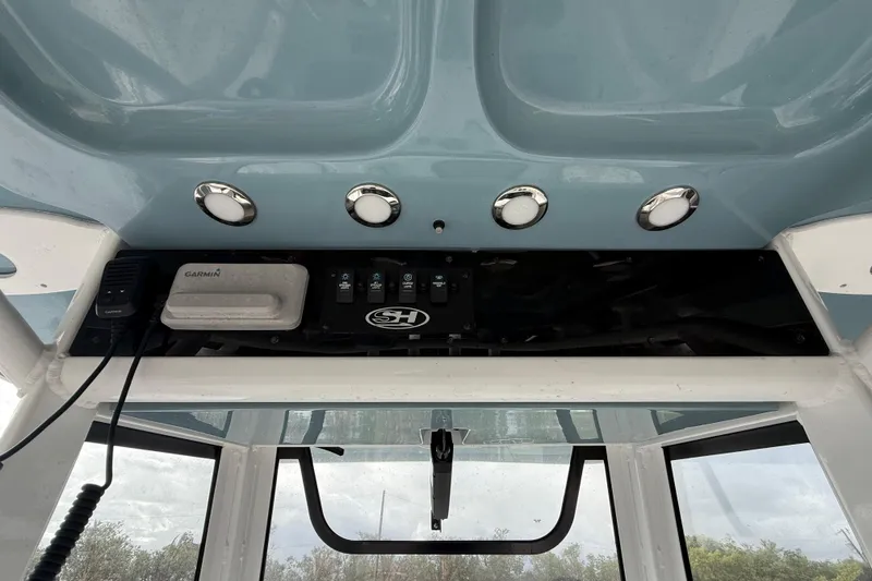 Slide: The Image of 2021 Sea Hunt Ultra 255 SE boat console with Garmin electronics and control switches. - 16