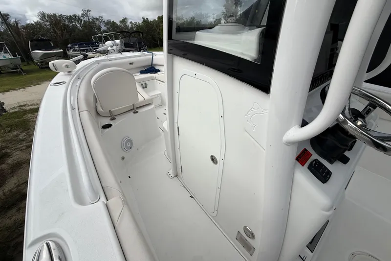 Slide: The Image of 2021 Sea Hunt Ultra 255 SE boat interior, featuring helm and seating area. - 17