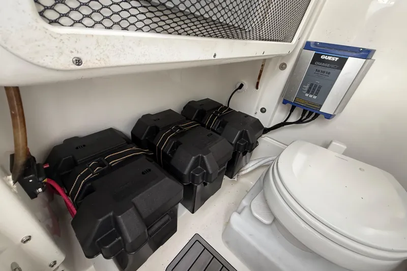 Slide: The Image of Battery compartment and toilet in 2021 Sea Hunt Ultra 255 SE boat. - 19