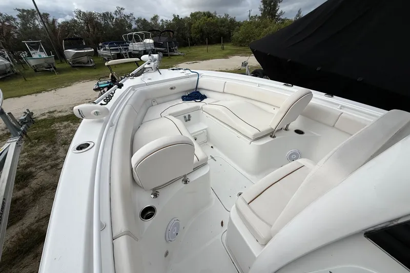 Slide: The Image of 2021 Sea Hunt Ultra 255 SE boat interior with white seating and spacious layout. - 20