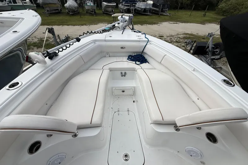 Slide: The Image of 2021 Sea Hunt Ultra 255 SE boat interior with white seating and storage compartments. - 23