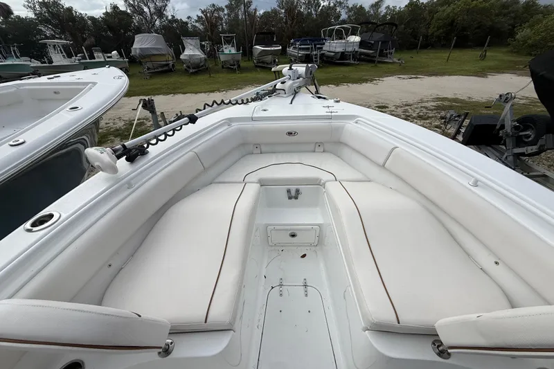 Slide: The Image of 2021 Sea Hunt Ultra 255 SE boat interior with white cushioned seating. - 25