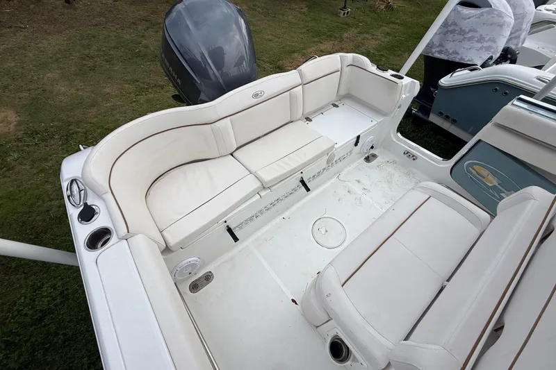 Slide: The Image of 2021 Sea Hunt Ultra 255 SE boat interior with white seating and Yamaha engine. - 27
