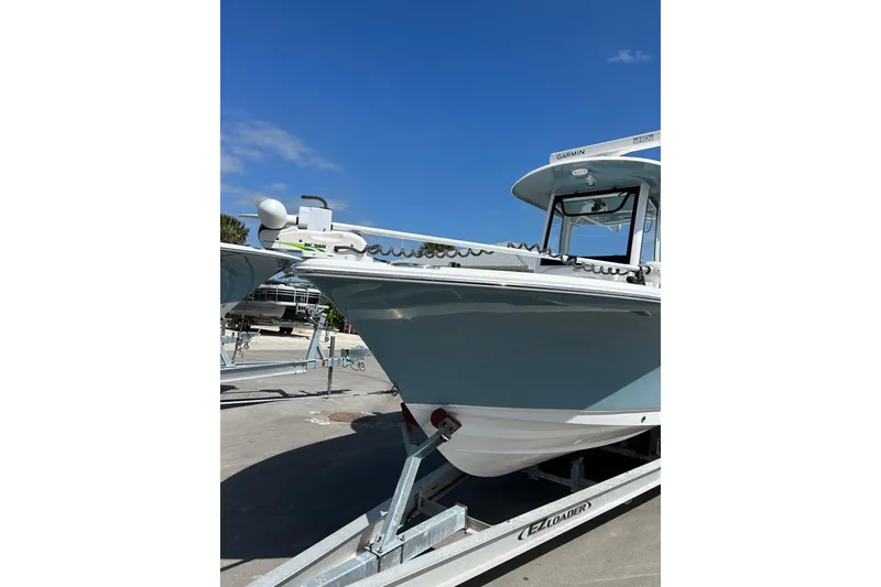 Slide: The Image of 2021 Sea Hunt Ultra 255 SE boat on trailer under clear blue sky. - 3