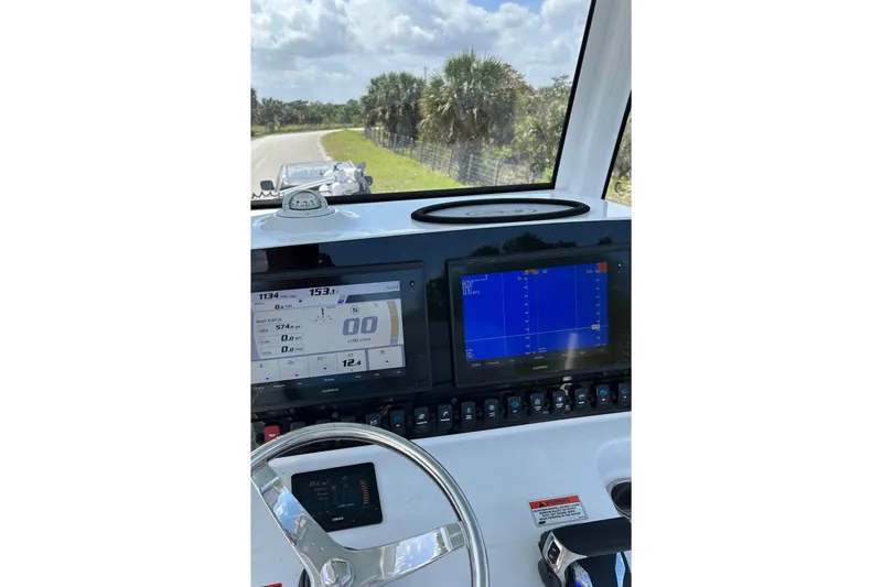 Slide: The Image of Dashboard view of 2021 Sea Hunt Ultra 255 SE boat with navigation screens. - 6