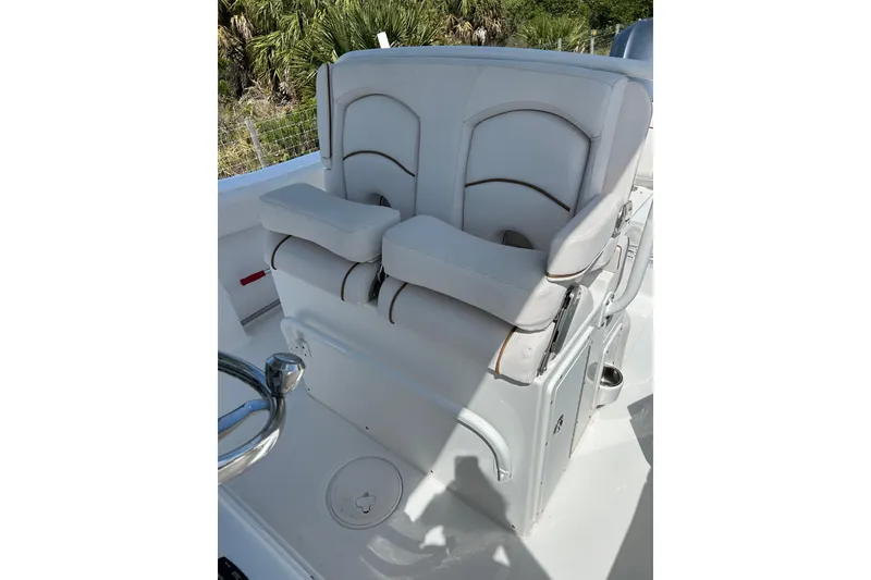 Slide: The Image of 2021 Sea Hunt Ultra 255 SE boat seating, featuring plush white cushions and ergonomic design. - 7