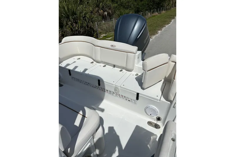 Slide: The Image of 2021 Sea Hunt Ultra 255 SE boat interior with seating and engine view. - 9