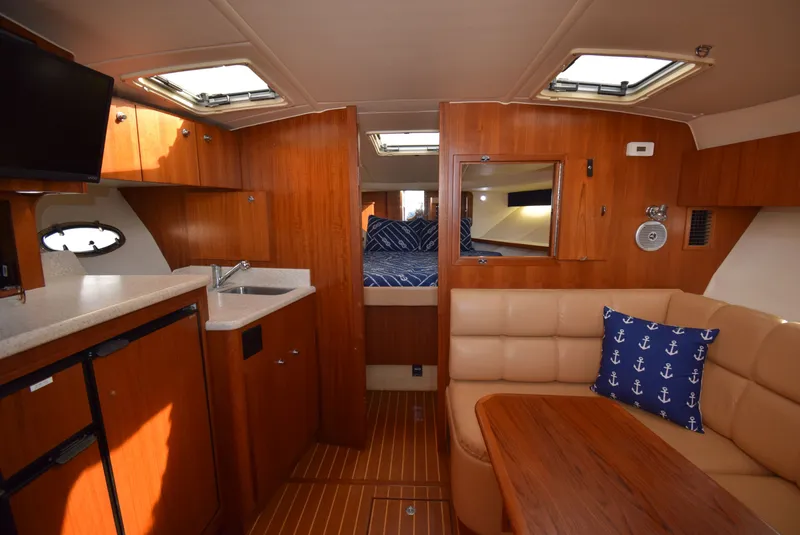 Slide: The Image of Interior of 2001 Tiara Yachts 3500 Open with kitchen and seating area. - 28