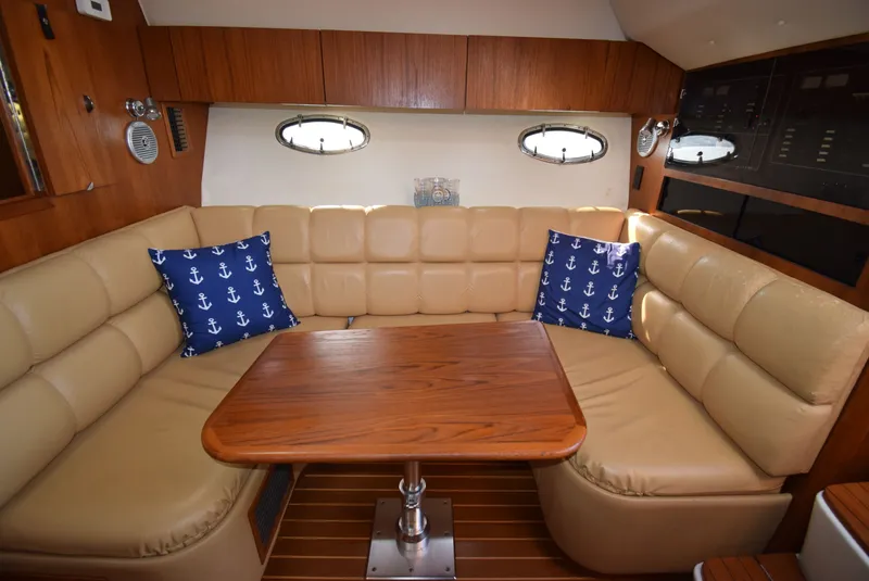 Slide: The Image of Interior of 2001 Tiara Yachts 3500 Open with leather sofa and wooden table. - 29