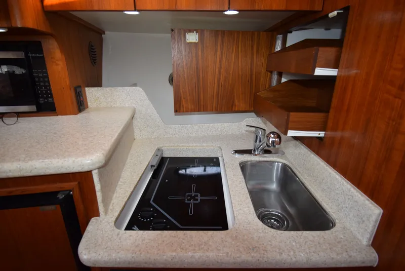 Slide: The Image of Tiara Yachts 3500 Open 2001 kitchen area with sink and stove. - 40