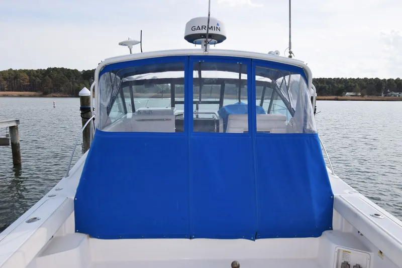 Slide: The Image of 2001 Tiara Yachts 3500 Open with blue cover at dock. - 9