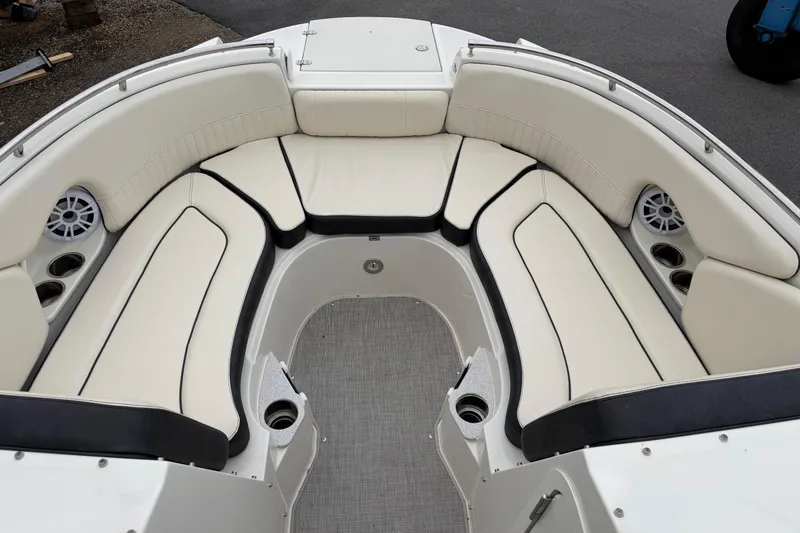 Slide: The Image of 2022 Stingray 231 DC boat interior with spacious seating and cup holders. - 3