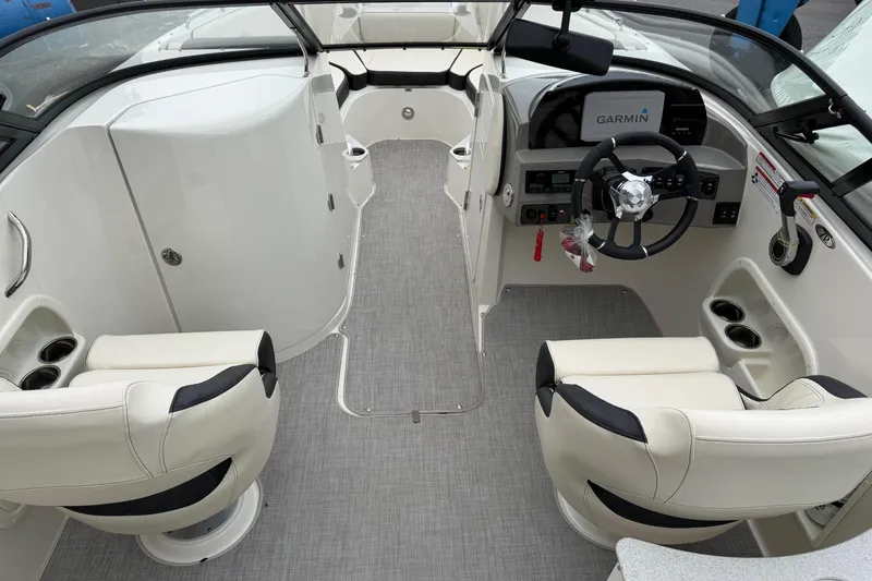 Slide: The Image of 2022 Stingray 231 DC boat interior with dual seating and Garmin navigation system. - 5