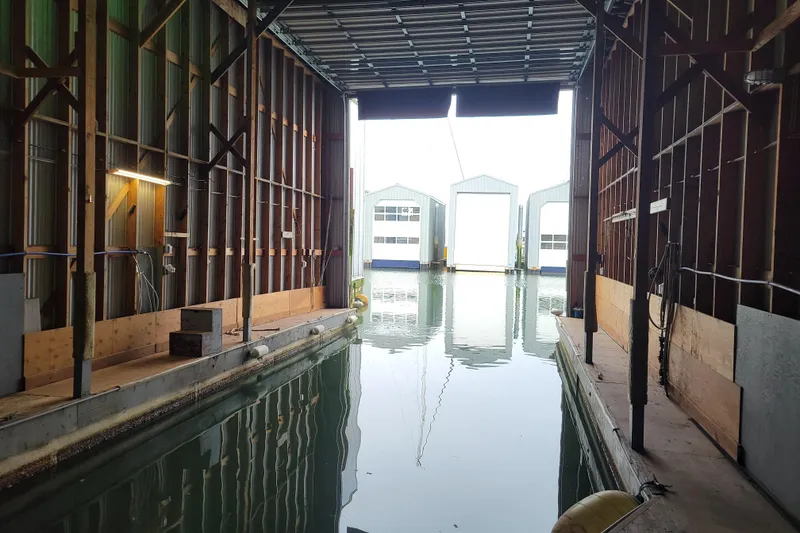 Slide: The Image of Interior view of a custom boathouse with water access, built in 2015. - 2