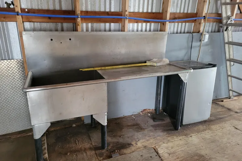 Slide: The Image of Industrial stainless steel sink and counter in a custom 2015 boathouse interior. - 5